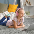Cute little girl with laptop at home. Concept of online education